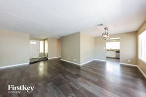 Phoenix house for rent - the living room and dining room of an apartment with hardwood flooring