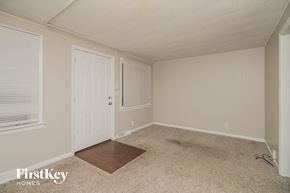 Zion house for rent - a bedroom with a white door and a carpeted floor