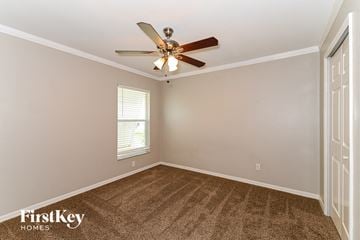 Cape Coral house for rent - a living room with a ceiling fan and a carpet