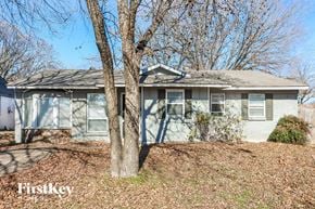 Plano house for rent - A house with a tree in front of it.