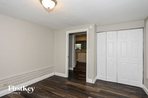 Miami Gardens house for rent - the living room of an apartment with white walls and wood floors