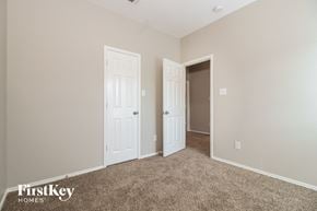 Denton house for rent - a bedroom with two doors and a door to a closet