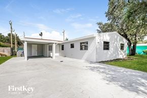 Hollywood house for rent - a white home with a driveway and a white house