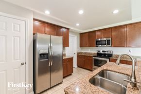 Cape Coral house for rent - a kitchen with stainless steel appliances and granite counter tops