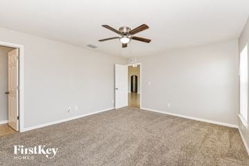 Cape Coral house for rent - a living room with carpet and a ceiling fan