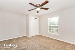 Cape Coral house for rent - a bedroom with a ceiling fan and a window