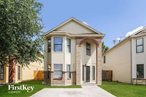 Houston house for rent - a white and brick house with a sidewalk and grass