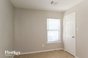 Houston house for rent - a bedroom with a window and a white door