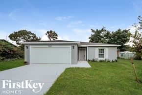 Port St. Lucie house for rent - A white house with a garage is shown with the words "FirstKey Homes" on the bottom left.