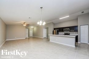 Port St. Lucie house for rent - A spacious kitchen and living room with a white ceiling and tiled floor.