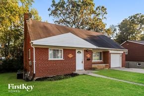 Cincinnati house for rent - a small brick house with a white door and a lawn