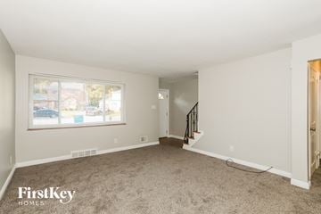 Cincinnati house for rent - a living room with carpet and a window