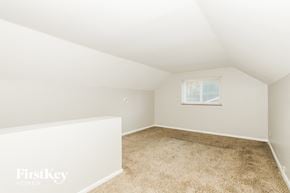 Cincinnati house for rent - a bedroom with white walls and carpet and a window
