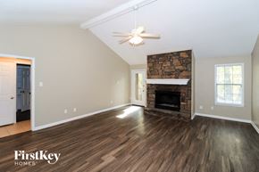 Lakeland house for rent - A spacious room with a fireplace and wood flooring.