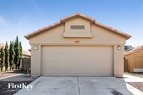 Phoenix house for rent - a white garage door on a house with a driveway