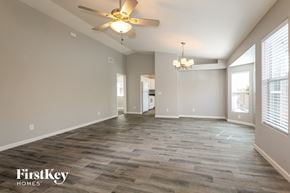 Phoenix house for rent - an empty living room with a ceiling fan and window