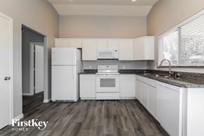 Phoenix house for rent - a white kitchen with white appliances and white cabinets