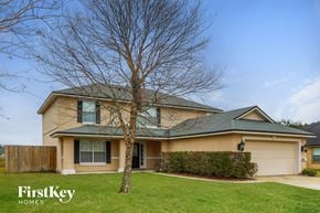 Green Cove Springs house for rent - the front of a yellow house with a tree in the yard