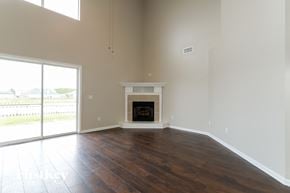 Green Cove Springs house for rent - an empty living room with a fireplace and a sliding glass door