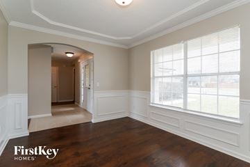 Green Cove Springs house for rent - the living room after remodeling with a large window and wood flooring