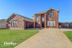Sachse house for rent - A brick house with a driveway in front of it.