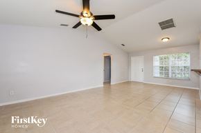 Lehigh Acres house for rent - the living room is spacious and clean with a ceiling fan