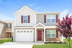 Dallas house for rent - A house with a red door and a white garage door.