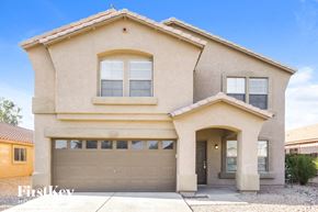 Phoenix house for rent - a beige house with a garage door