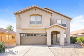 Phoenix house for rent - a house with a garage door in front of it