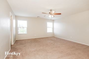 Phoenix house for rent - a living room with carpet and a ceiling fan