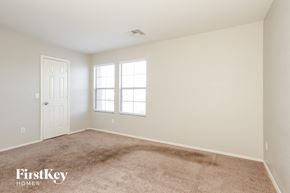 Phoenix house for rent - a bedroom with carpet and a white door and window
