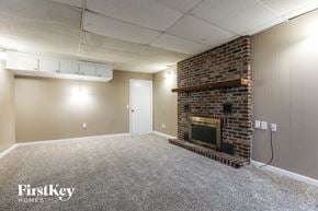 Independence house for rent - A room with a fireplace and a carpeted floor.