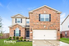 Forney house for rent - a brick house with a white garage door in front of it