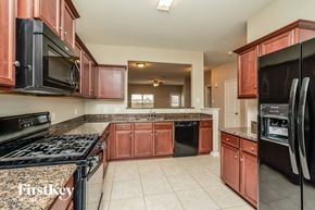 Forney house for rent - full view of the kitchen with granite countertops and black appliances