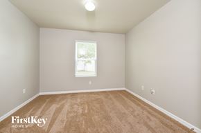 Cape Coral house for rent - a spacious room with carpet and a window