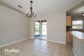 Lehigh Acres house for rent - an empty kitchen and living room with a sliding glass door