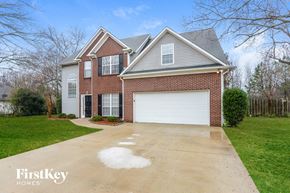 Helena house for rent - a brick house with a white garage door on a driveway