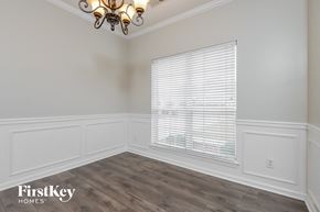Helena house for rent - the living room after remodeling with white walls and wood flooring
