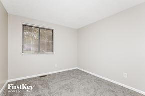 Indianapolis house for rent - a bedroom with carpet and a window