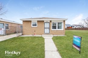 Blue Island house for rent - the front of a brick house with a yard and grass