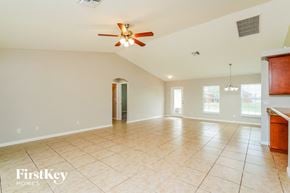 Cape Coral house for rent - A spacious room with a ceiling fan and tiled floor.