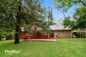 Memphis house for rent - A house with a lawn and trees in front of it.