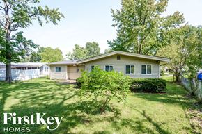 Florissant house for rent - A house with a lawn and trees in the background is for sale through FirstKey Homes.