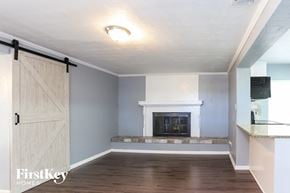 St. Petersburg house for rent - a living room with a fireplace and a barn door
