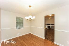 Atlanta house for rent - the living room and dining room of an empty house with wood flooring and a