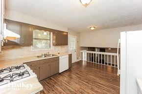 Atlanta house for rent - a kitchen with a stove top oven and a sink