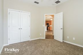 Kissimmee house for rent - a bedroom with two closets and a carpeted floor