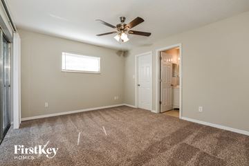 Winter Park house for rent - a living room with carpet and a ceiling fan