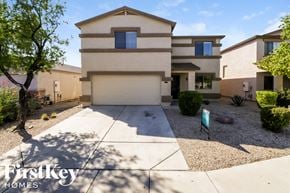 San Tan Valley house for rent - A house with a driveway and a tree in front of it.