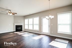 Mcdonough house for rent - a living room with large windows and a ceiling fan
